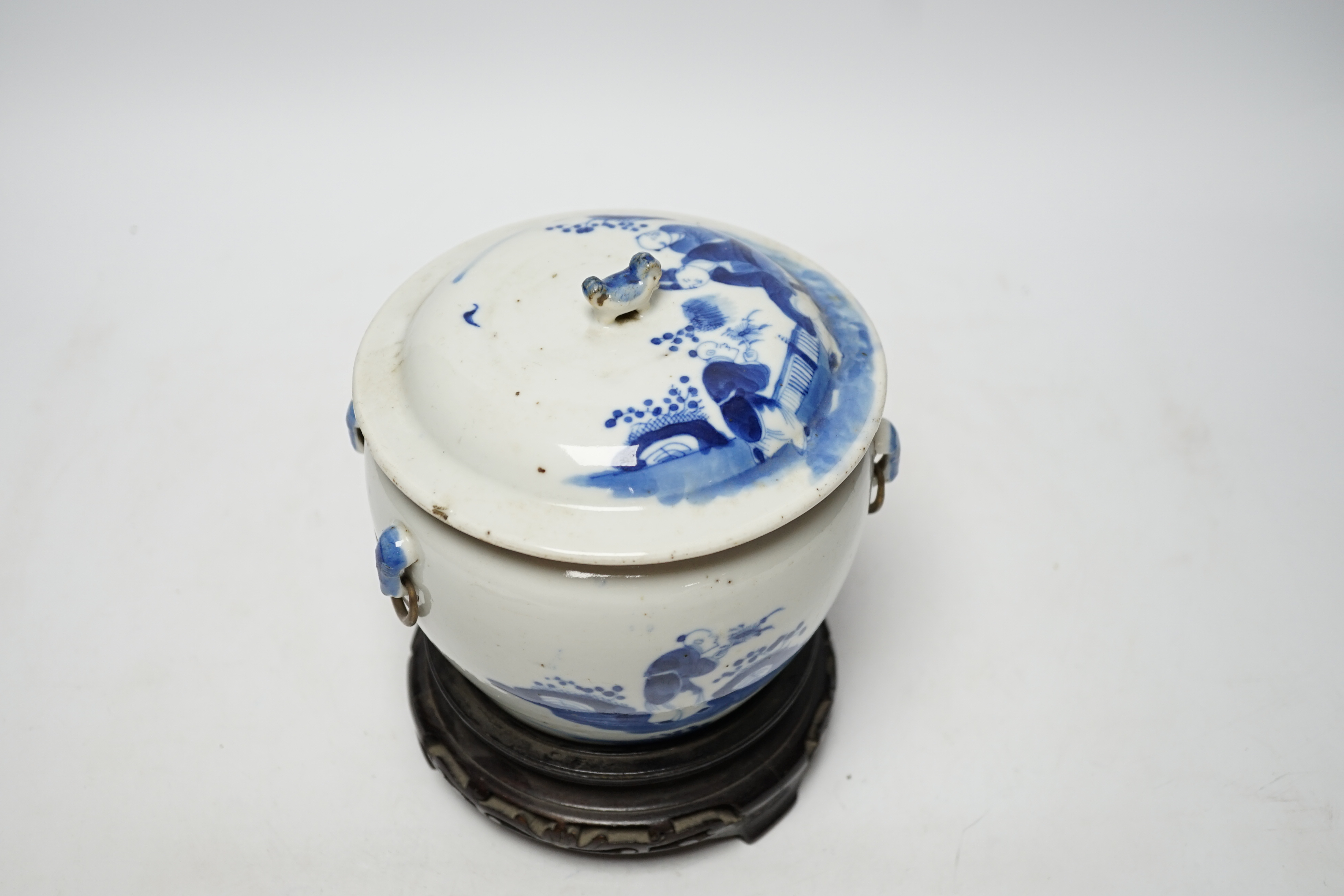 A Chinese Straits blue and white bowl and cover, kamcheng, late 19th century, with twin handles, on hardwood stand, 19cm high